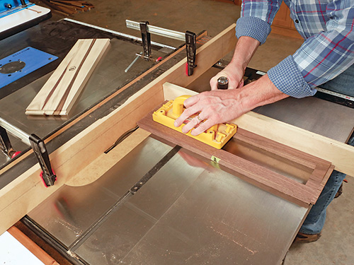 Using table saw to cut tongue for cabinet rail installation