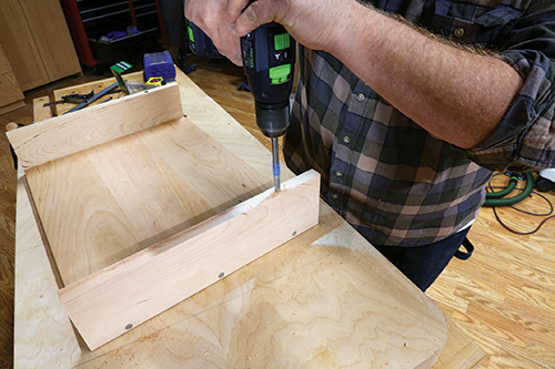 Using drill/driver to cut hole for fastening chevron table shelf