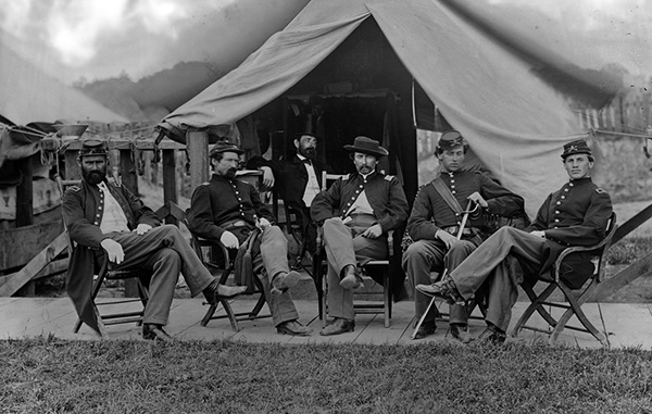 Civil war officers sitting in front of camp