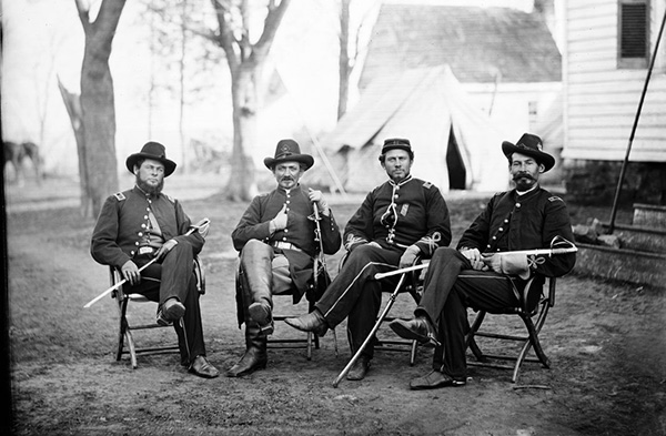 Civil war officers sitting outside a home