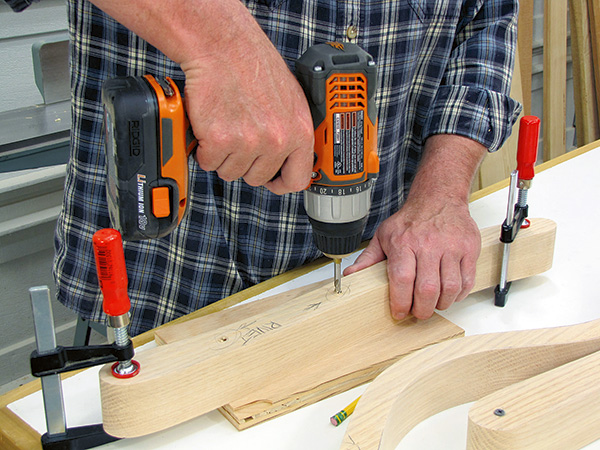 Adding rivets to chair parts with drill driver