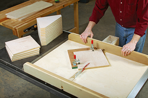 Angle-cutting the 16 braces to shape is quick and safe with a crosscut sled. Here the author secures each blank for cutting with a pair of toggle clamps mounted on fences that are attached to the sled’s bed.