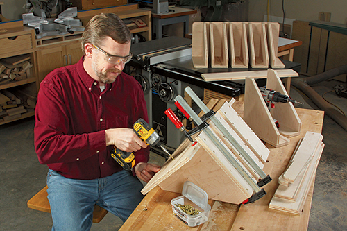 Clamp and tack the bridge subassemblies to the rack back panels before reinforcing the joints with 2" countersunk deck screws. Space the bridge and end subassemblies 11⁄4" apart to form long slots for the clamps.