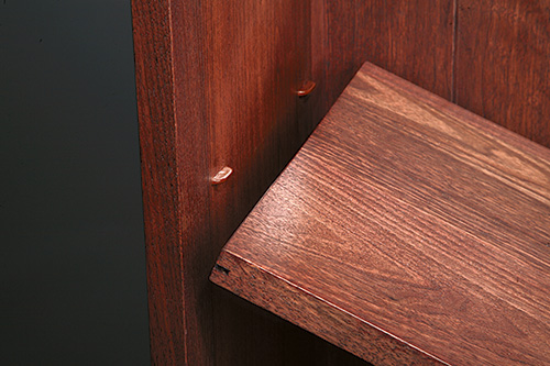 Close-up of shelf ends on walnut bookcase