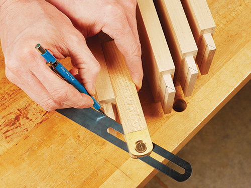 Marking cut angle with a bevel gauge on drop-leaf table leg
