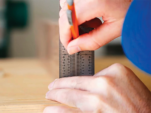Using a ruler to mark table leg blanks for cutting