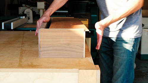 Fitting drawer bottom into grooves in carcass