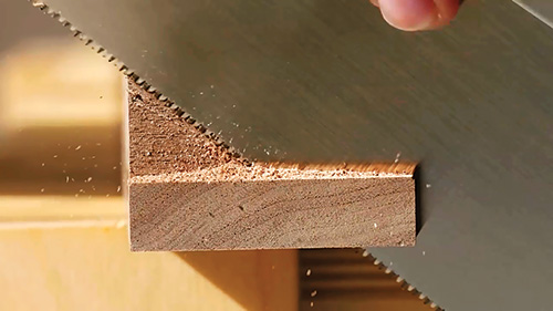 Trimming hall table braces with a hand saw