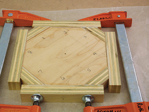 Plywood pieces clamped around an octagonal center