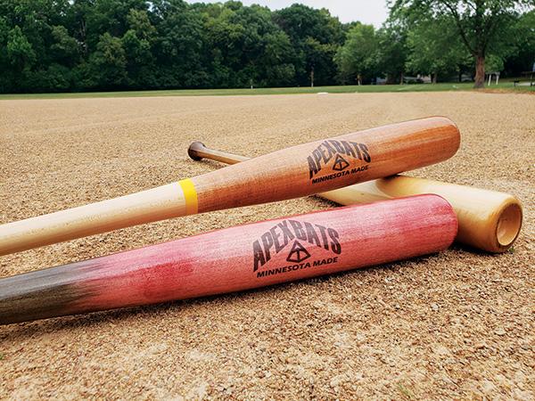 Three stained turned Apex baseball bats