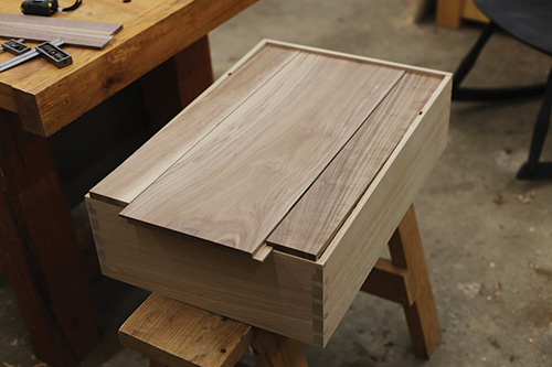 Sliding dovetailed whiskey cabinet back panel into place