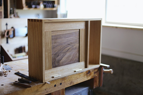 Completed and attached door panel in dovetailed whiskey cabinet