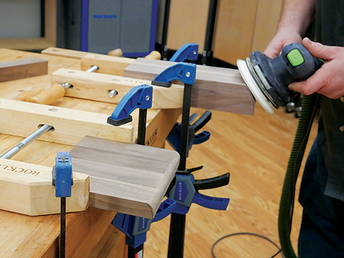 Sanding down sharp edges on knife storage block