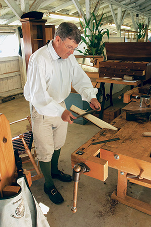 Ernie Conover making cuts with a drawknife