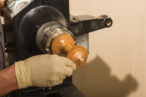 Applying a varnish finish to earring stand shaft