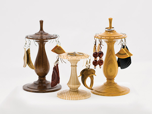 Three examples of three turned earring stands