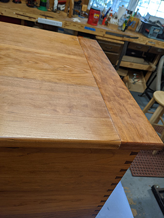 Corner view of cherry elevator chest