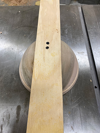 Centering screw holes in straightedge piece