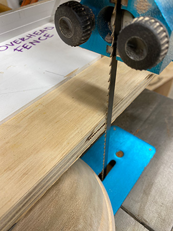 Guiding bowl blank cut with straightedge and pattern fence