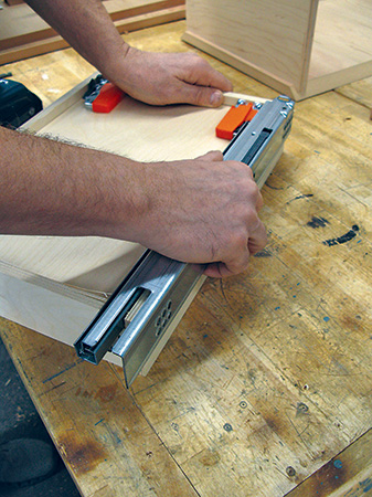 Checking drawer slides against carcass for installation