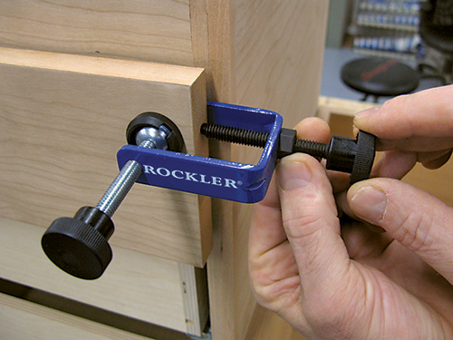 Attaching clamp to drawer face while drawer is closed