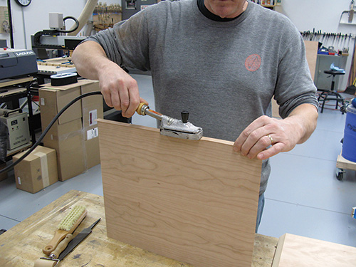 Applying veneer tape to entry bench panels