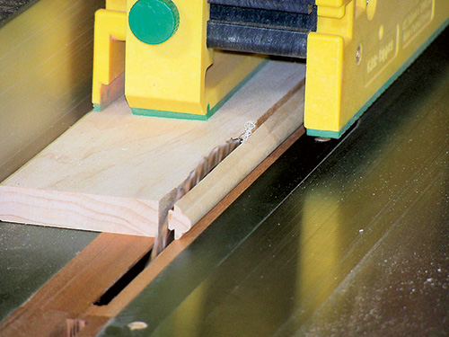 Ripping molding pieces with zero-clearance blade on table saw for envelope table