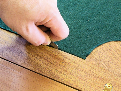 Tucking excess felt into recessed envelope tabletop