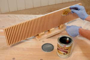Mounting the blank of dentil on-edge to a scrap base allows gravity to take care of excess finish and hold it while it dries. Brush it on liberally and don't worry about it.