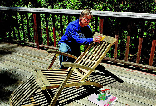 Applying finish to a wood deck chair