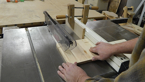 Make the stretcher notch cheek cuts on the table saw by clamping a stop block to the fence, so you don’t cut too far and into the angled shoulders. Finish these cuts with a hand saw.