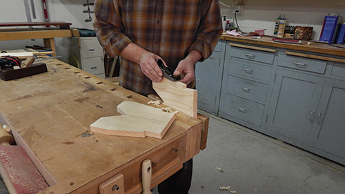Once the legs are cut to final shape, use a block plane or sanding block to clean off any saw marks that remain.