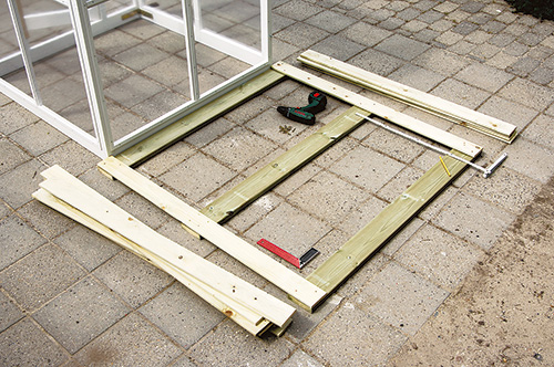 Laying out decking boards for fold-out greenhouse base