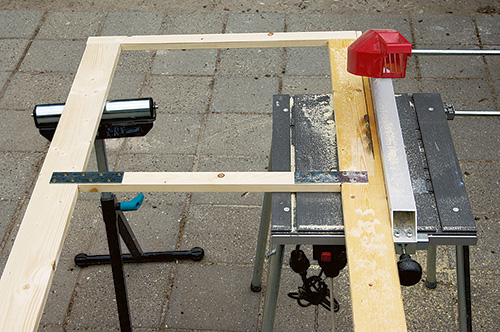 Cutting excess off attached panels for fold-up greenhouse