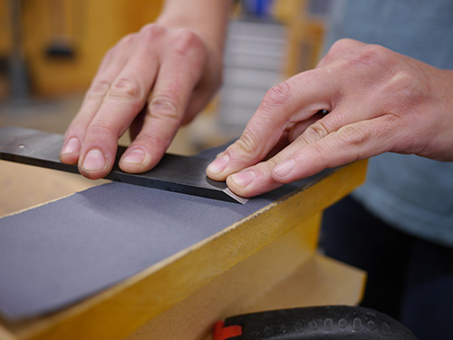 Flattening plane blade with fine grit sandpaper