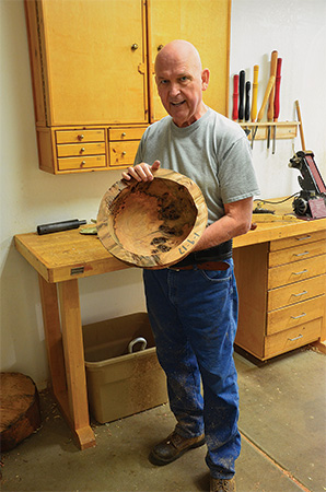Woodworker displaying a turned bowl