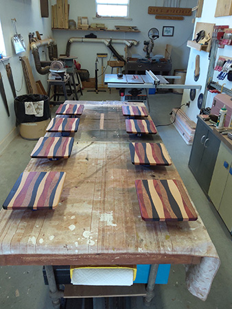 Four wood cutting boards being assembled