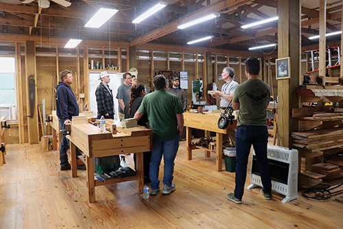 A class has a discussion at the Full Circle woodworking school