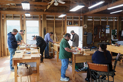 Students working at shop workbenches