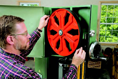 Heavy, cast-iron flywheels help the saw’s motor drive big blades through thick or wide material.