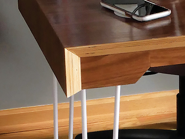 Desk corner with exposed plywood edges