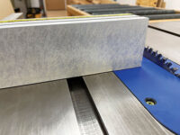 Adhesive layer on table saw crosscut fence