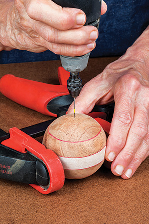 Screwing hole into the top of ornament