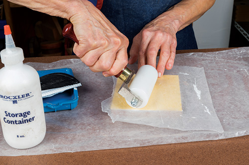 Rolling veneer over a blank