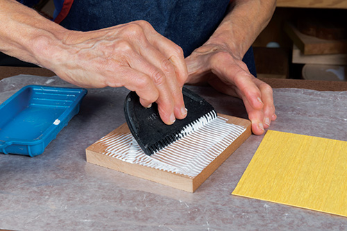 Using glue spreader to prepare for lamination