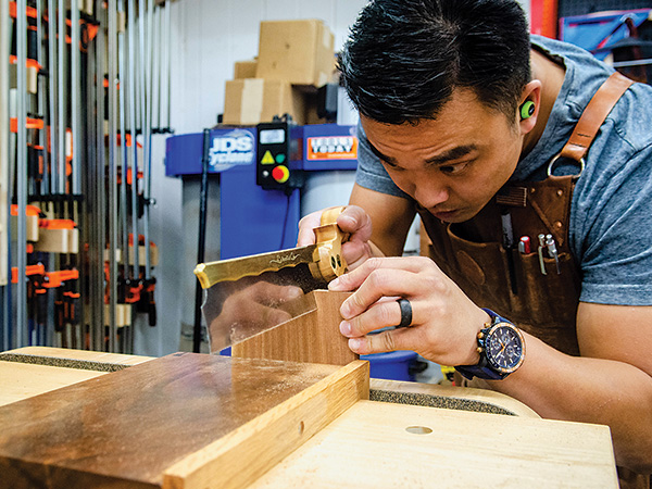 Huy Huynh cutting dovetails
