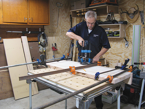 Drilling holes for spindles in bench with a drill guide