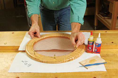 Laying out pins to store necklaces around frame