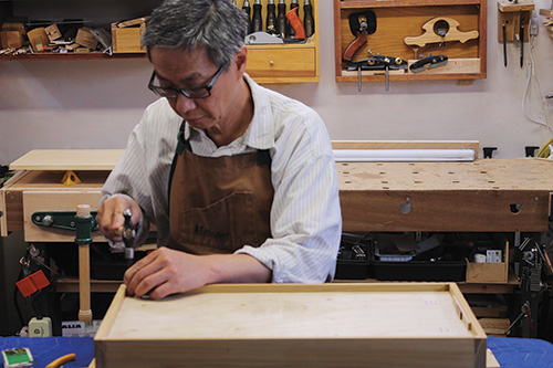 Putting shop cabinet back panel into place