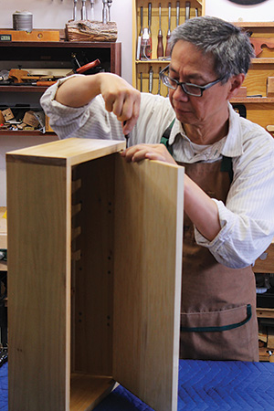 Installing bottom and top hinges to a cabinet door